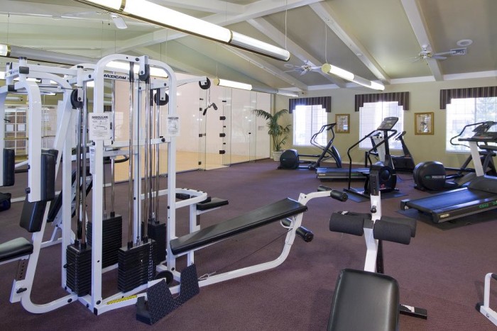 Fitness center with weight machines, cardio machines, and an indoor racquetball court.